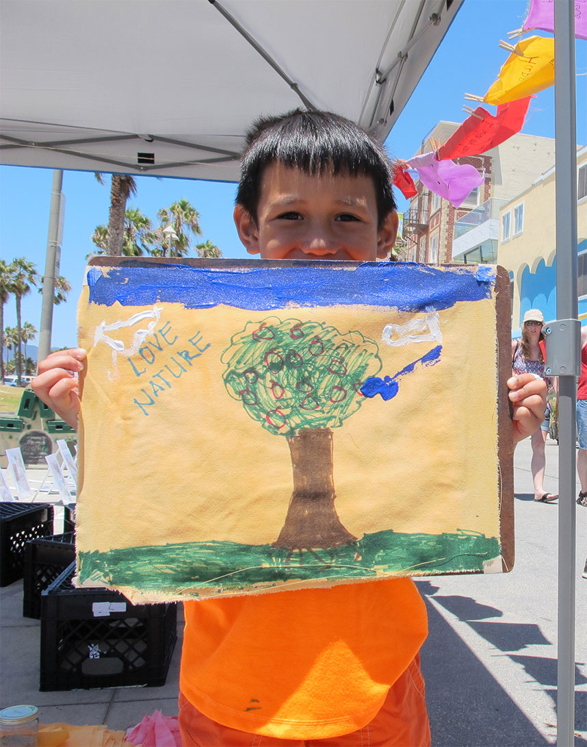 A child holding a hand-painted wish flag